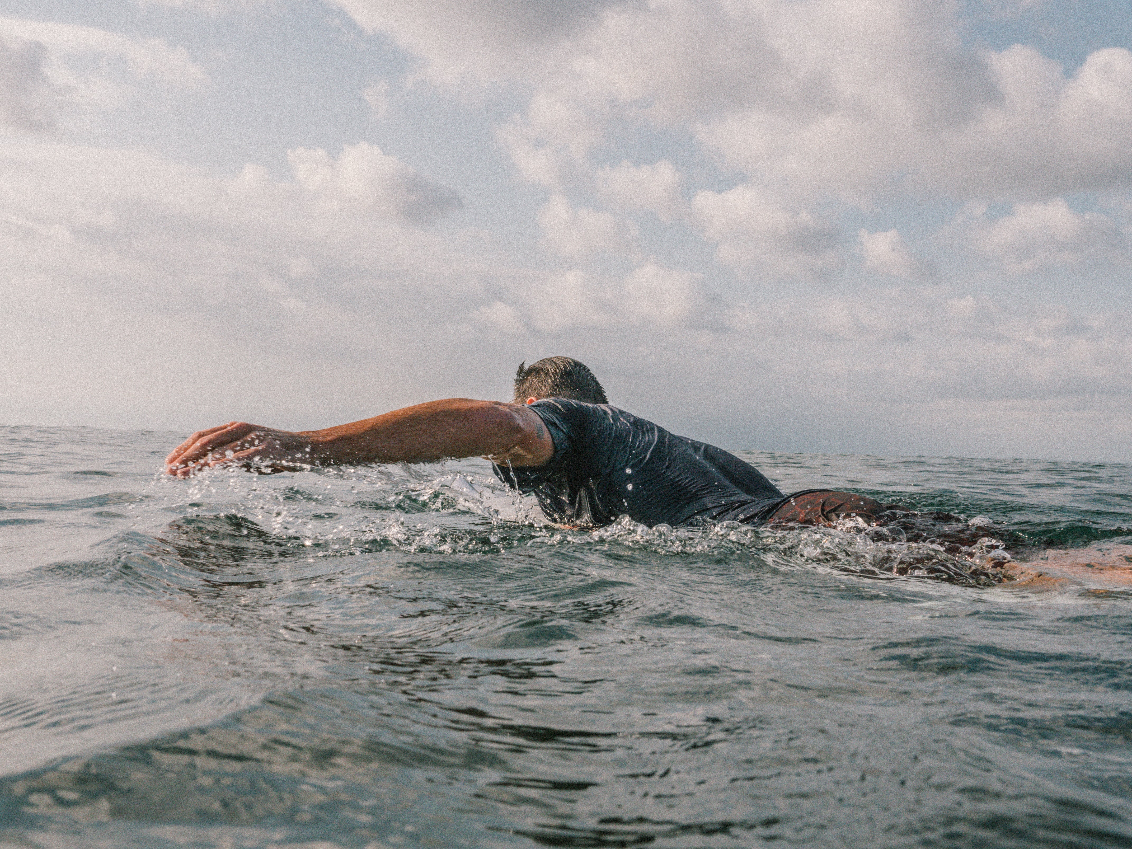 Picture of Surfer paddling out in the ocean on a small day.